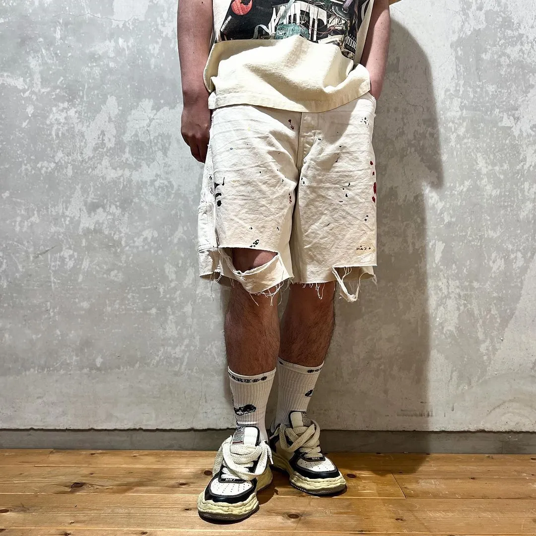 GALLERY DEPT. FLEA CARPENTER SHORTS Ink-cut knife-cut mud-dyed denim shorts. Destroy VINTAGE distressed denim shorts. Distressed white S-XL. Rewashed cement-dyed to make it old. Knife cut holes. Cat whiskers are worn. Customized full set with logo accessories. Purely handmade acrylic splash-ink graffiti.
